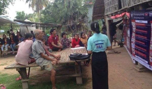 volunteer educating local cambodian about tansferable disease