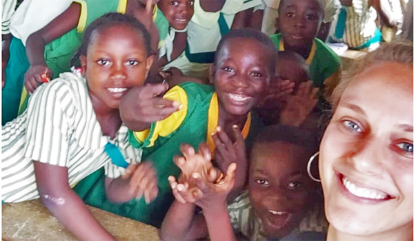 volunteer teaching child at orphanage
